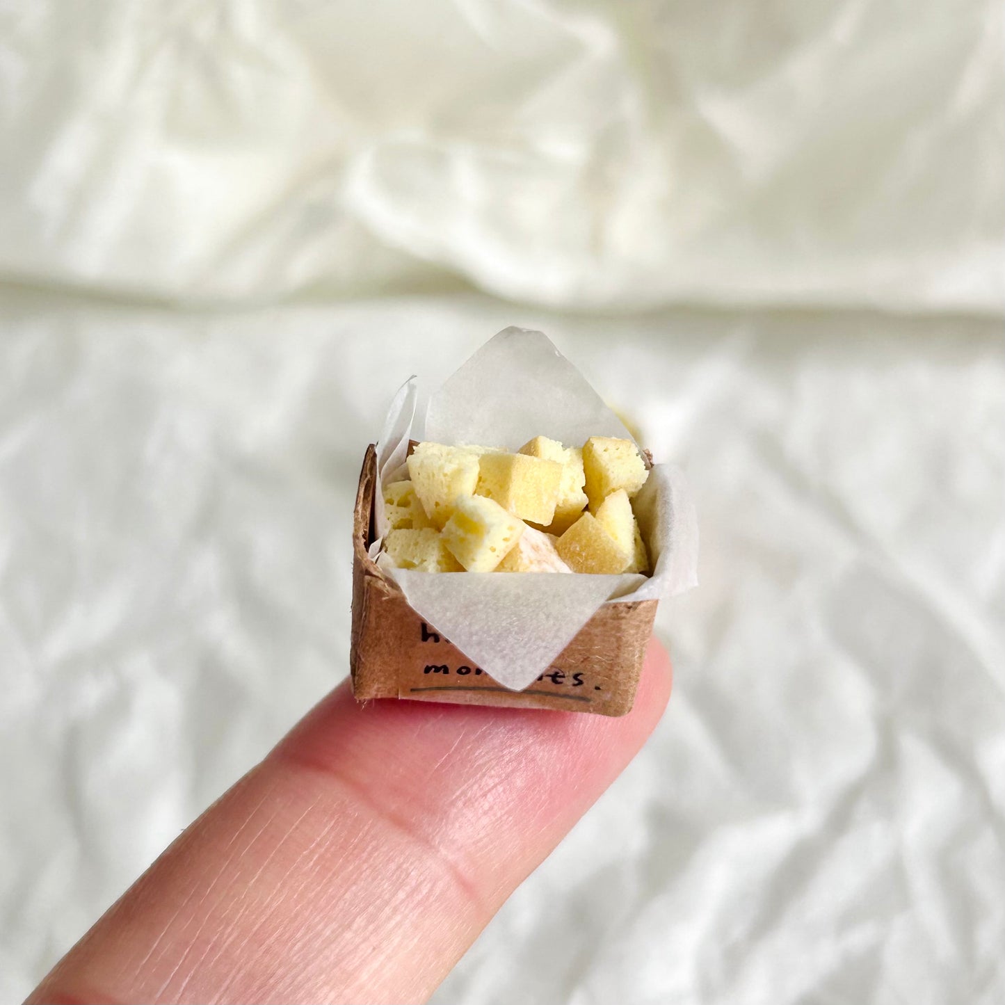 miniature baguette pieces without cheese topping in a paper box