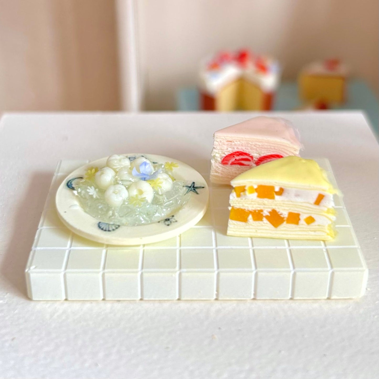 dollhouse dessert scene with miniature mille crepe cake
