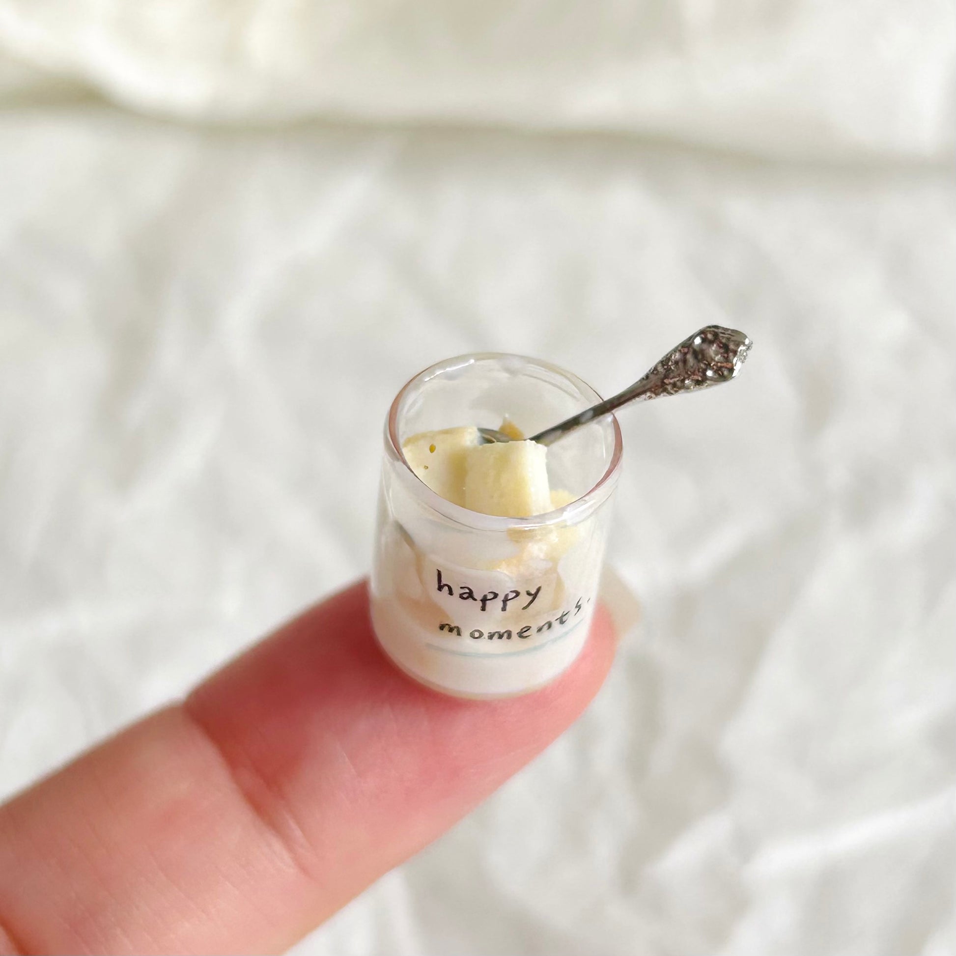 miniature bread pieces in a glass cup with small spoon
