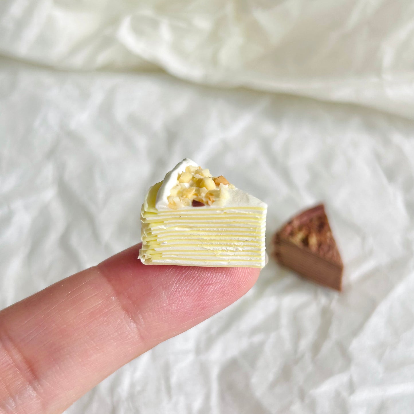 miniature original mille crepe cake with cream and nut topping