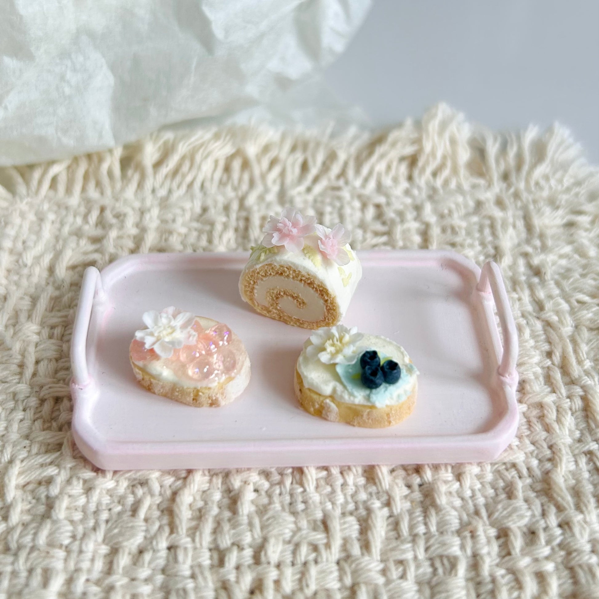 handmade miniature Swiss roll and decorated baguette slices