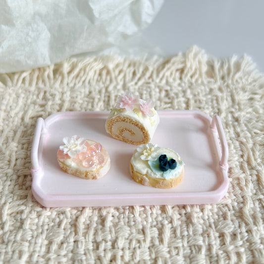 handmade miniature Swiss roll and decorated baguette slices