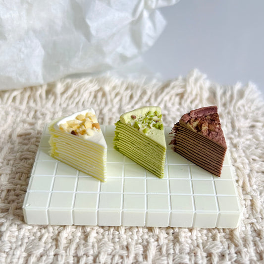 handmade miniature mille crepe cake with cream and nut topping