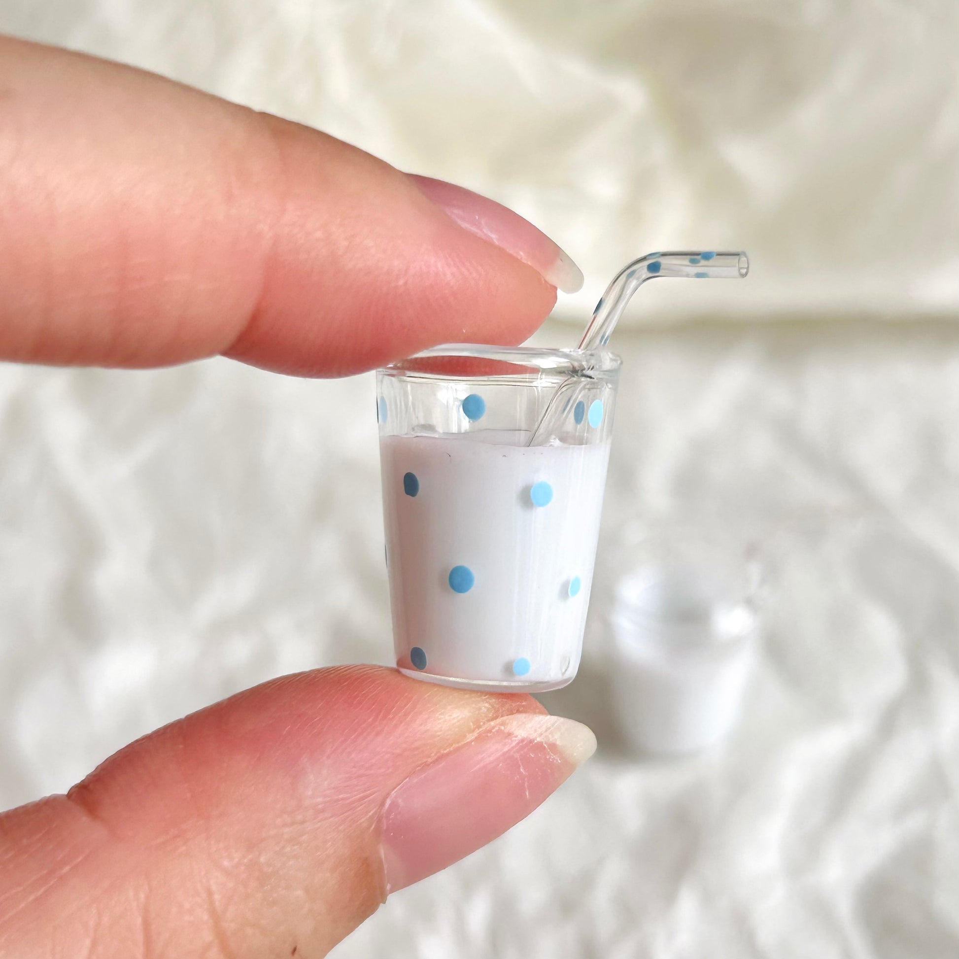 small miniature milk drink in a glass cup with straw