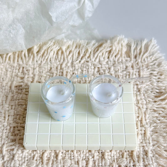 miniature milk glass with hand-painted polka dot decoration and glass straw