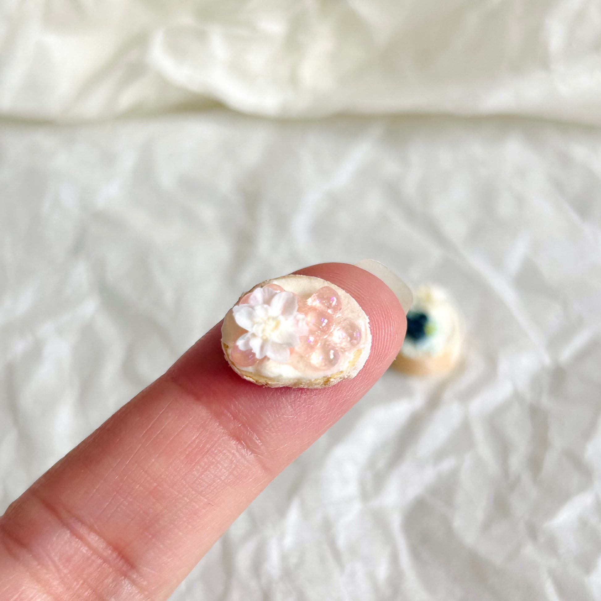 handmade miniature floral baguette slice held in hand