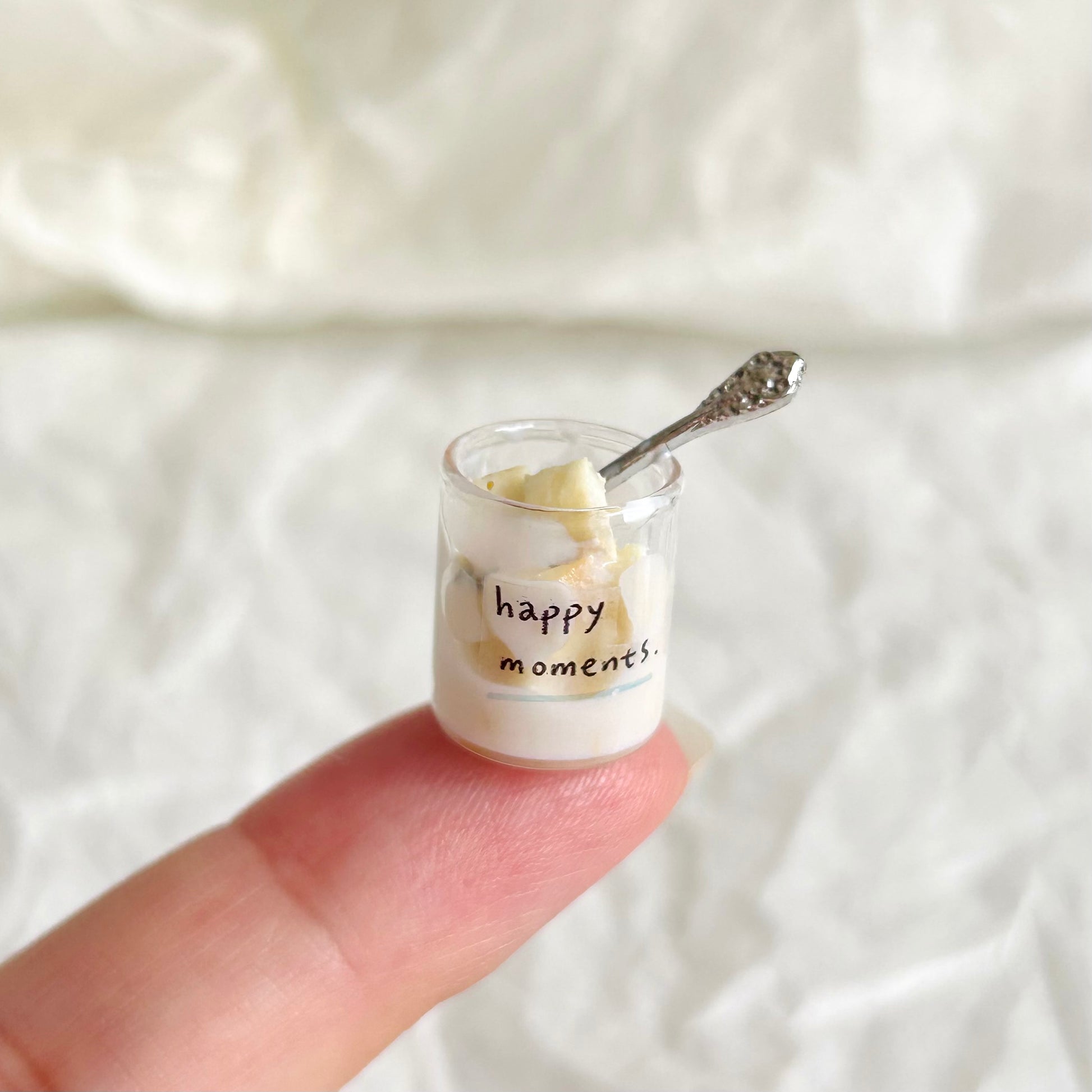 miniature condensed milk bread pieces in a glass cup with small spoon