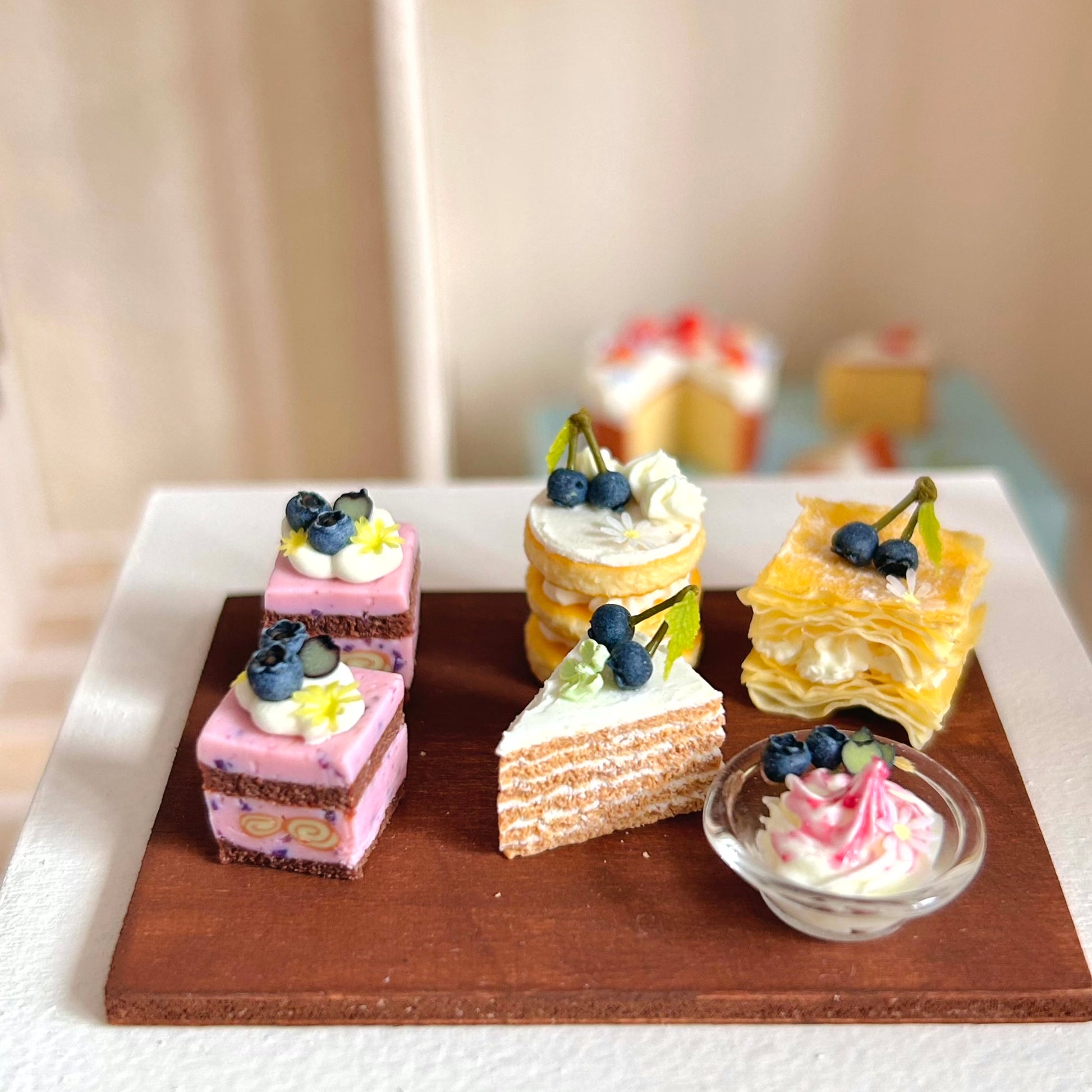 miniature dessert display featuring blueberry cube cake
