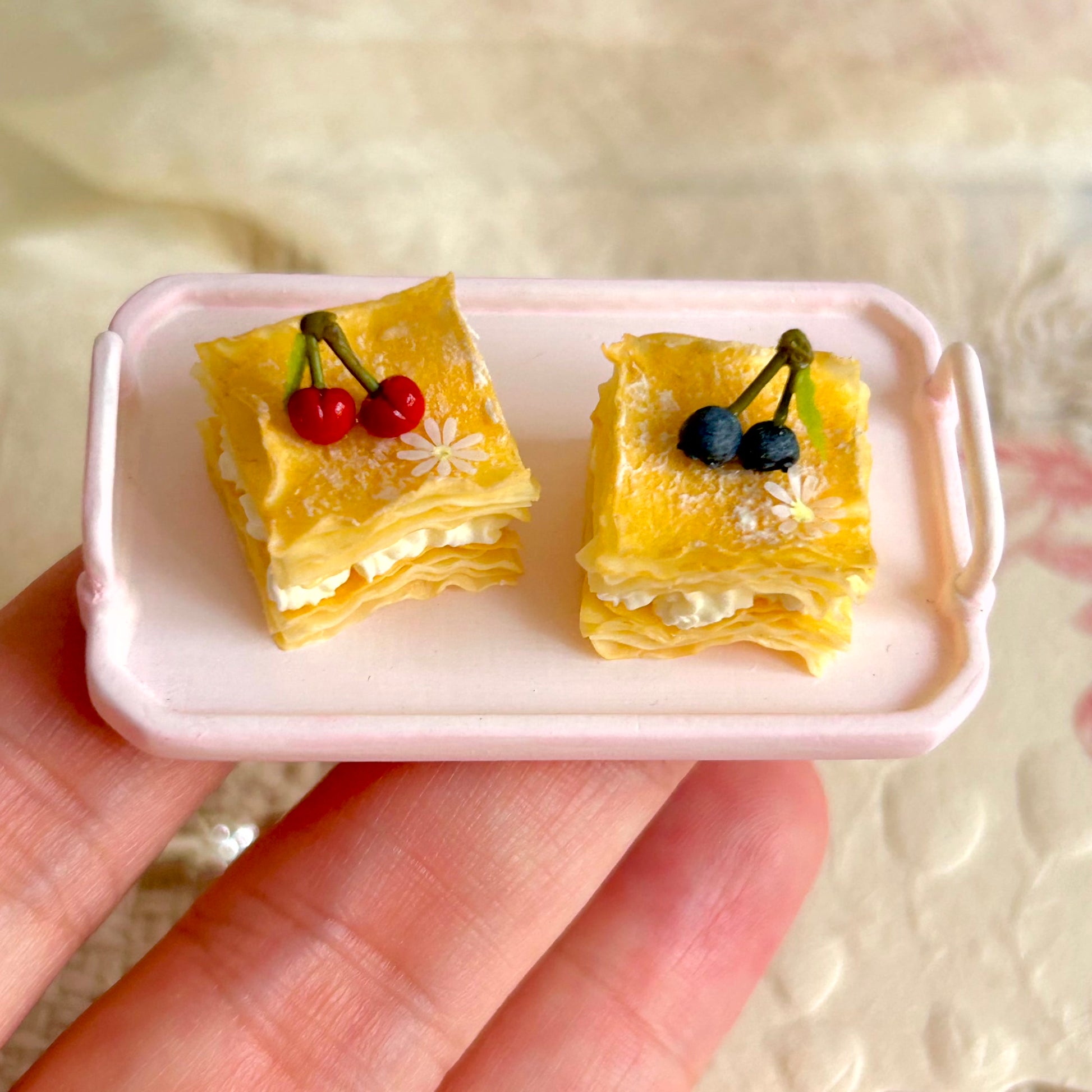 small scale handmade miniature mille feuille held in hand
