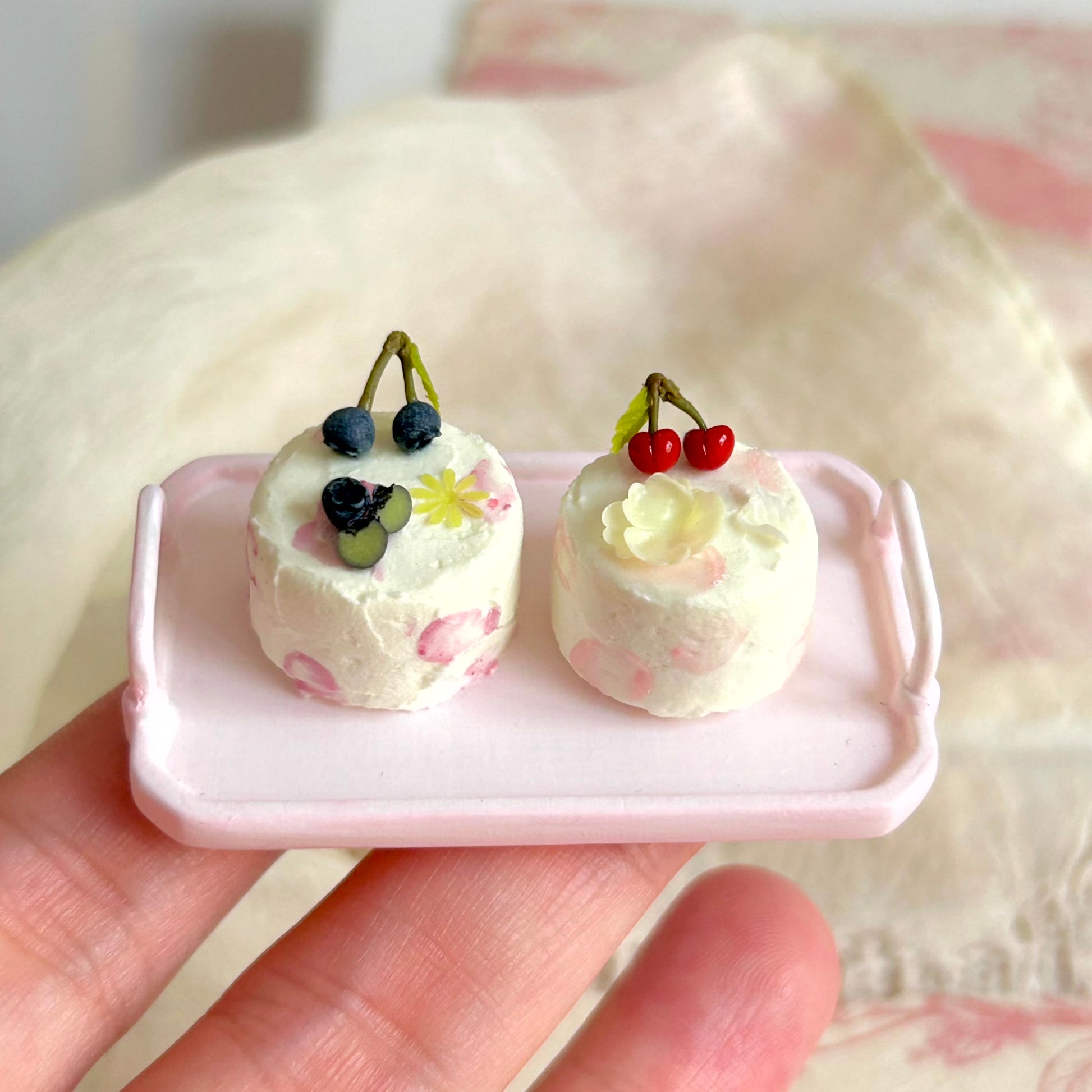 small scale handmade miniature dessert cake held in hand