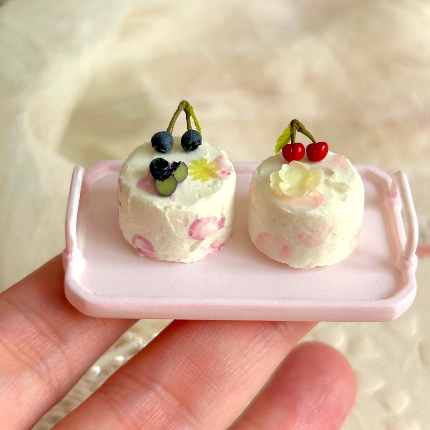 handcrafted miniature cake with realistic cream and fruit decoration