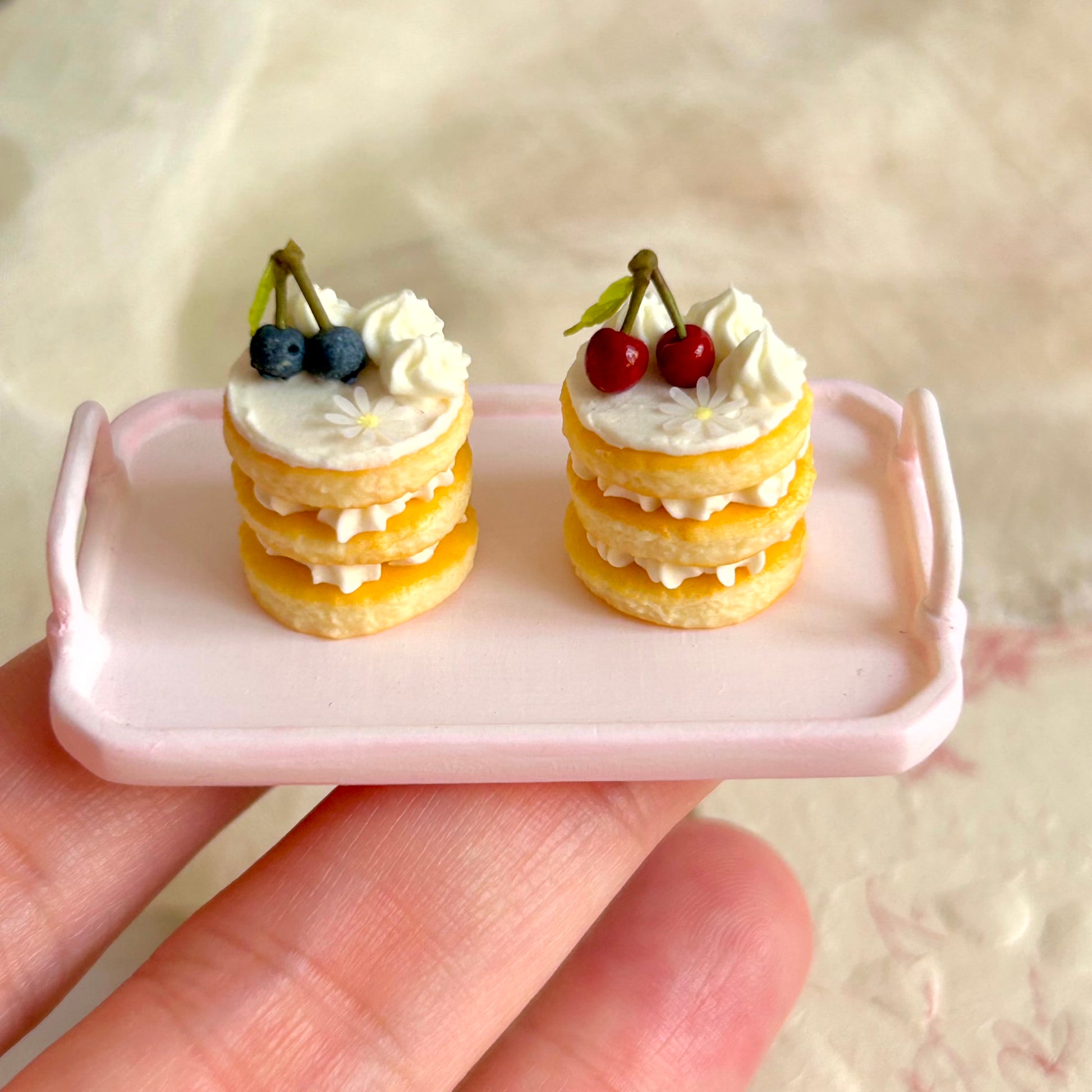 small realistic miniature cake held in hand

