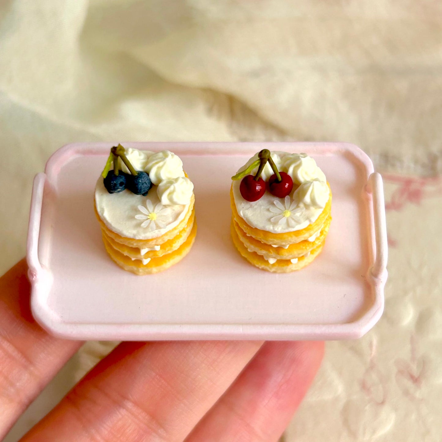 mini layered cake with cream filling and blueberry decoration