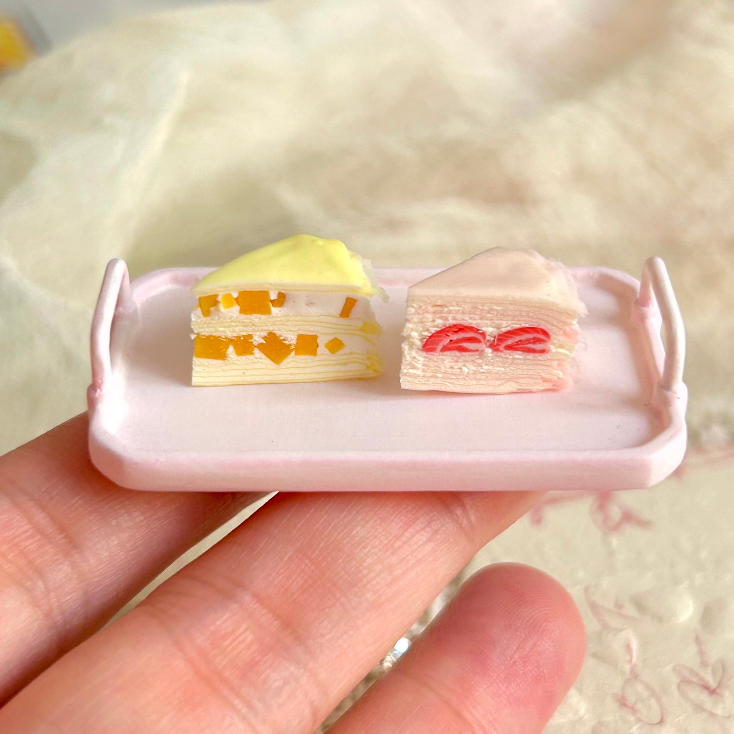 realistic miniature mille crepe cake with fruit filling and cream layers
