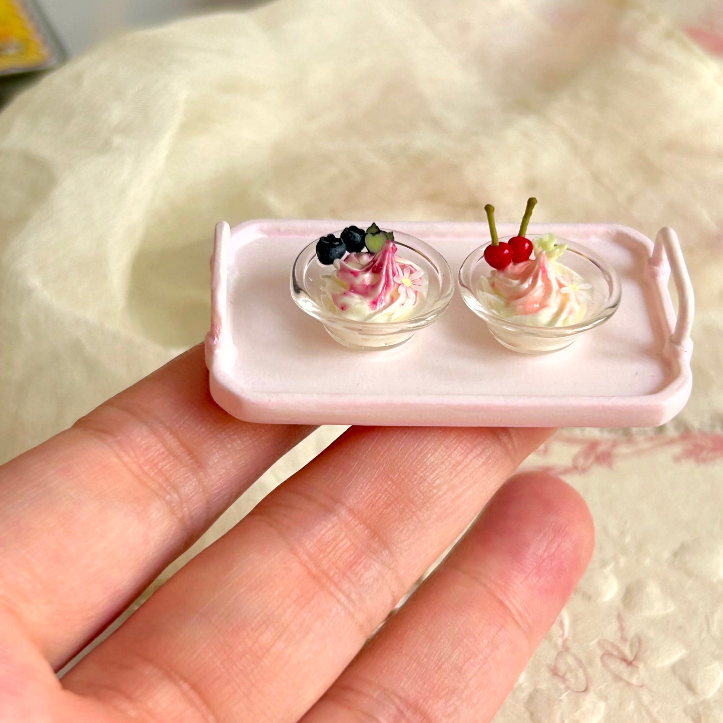 realistic miniature ice cream with cherry sauce in glass bowl