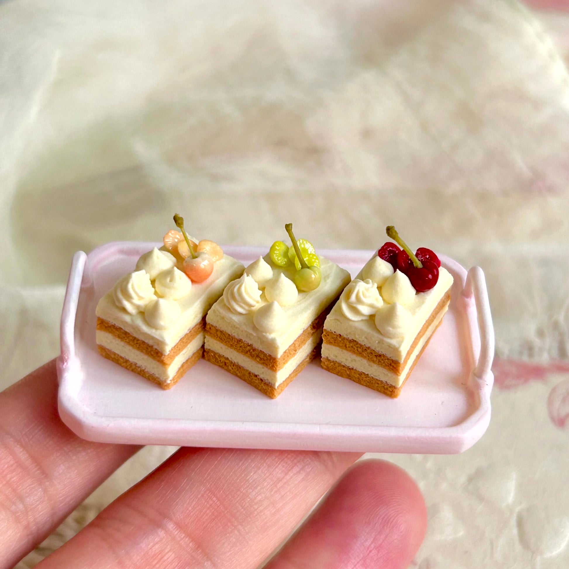 small scale handmade miniature cake slice held in hand
