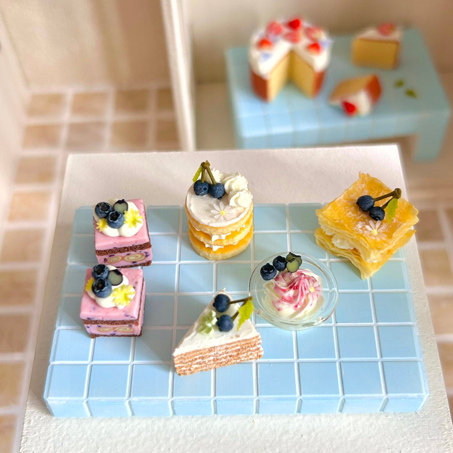 miniature round layered cake with cream and fruit topping