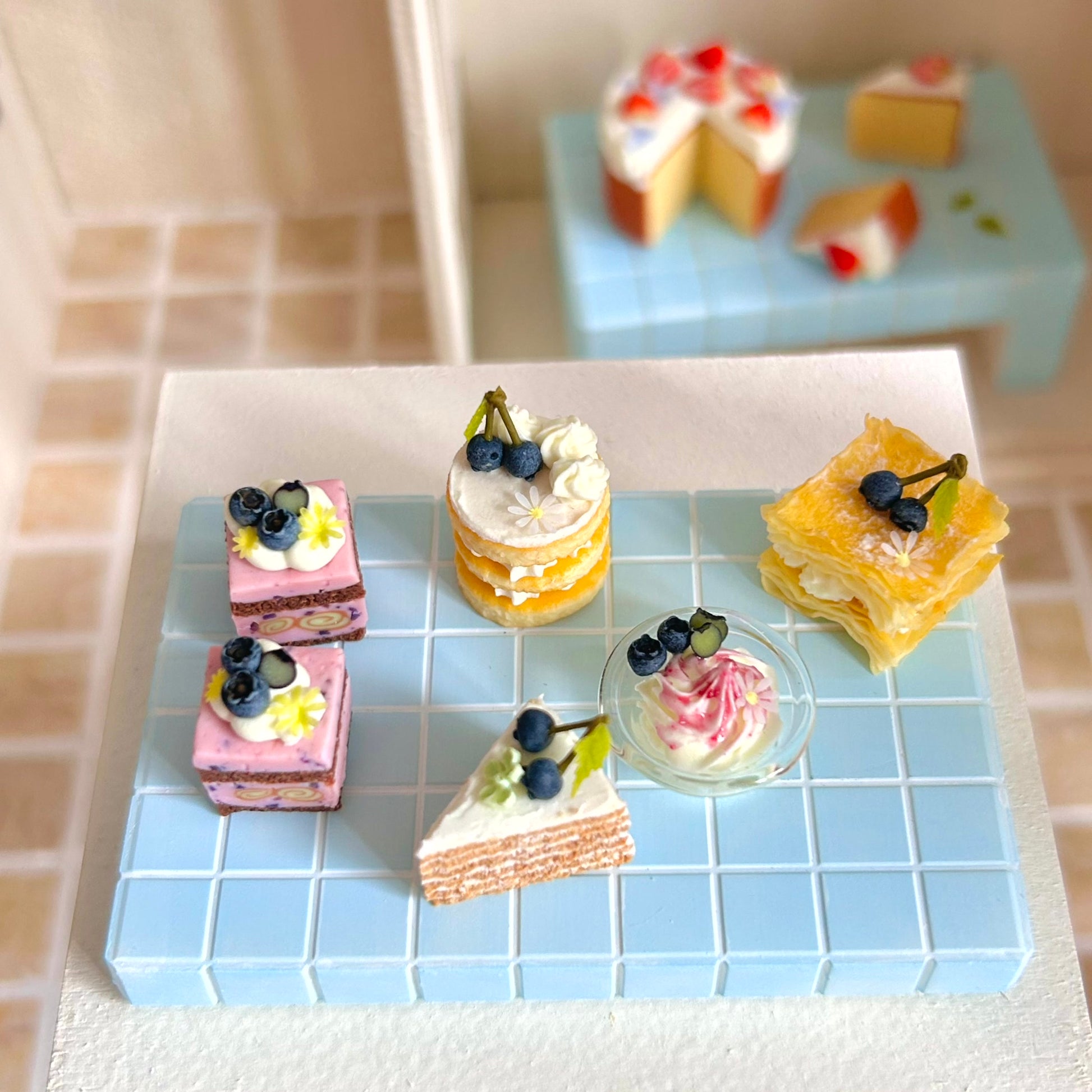 miniature round layered cake with cream and fruit topping