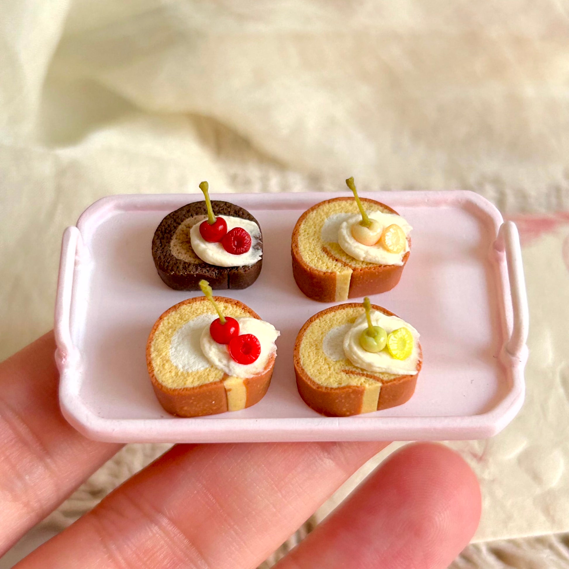 small handmade miniature swiss roll cake held in hand