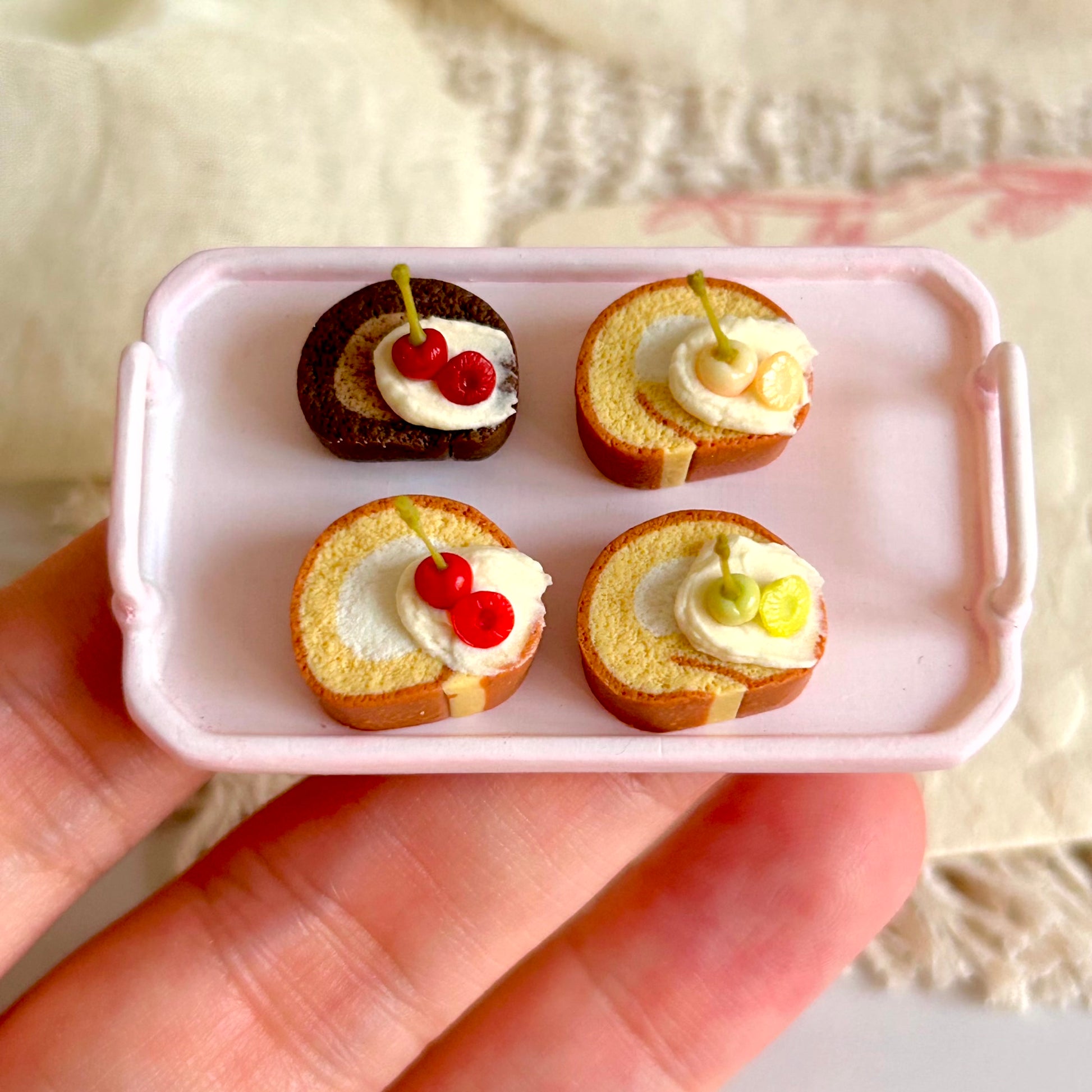 realistic miniature swiss roll with cream and cherry decoration details