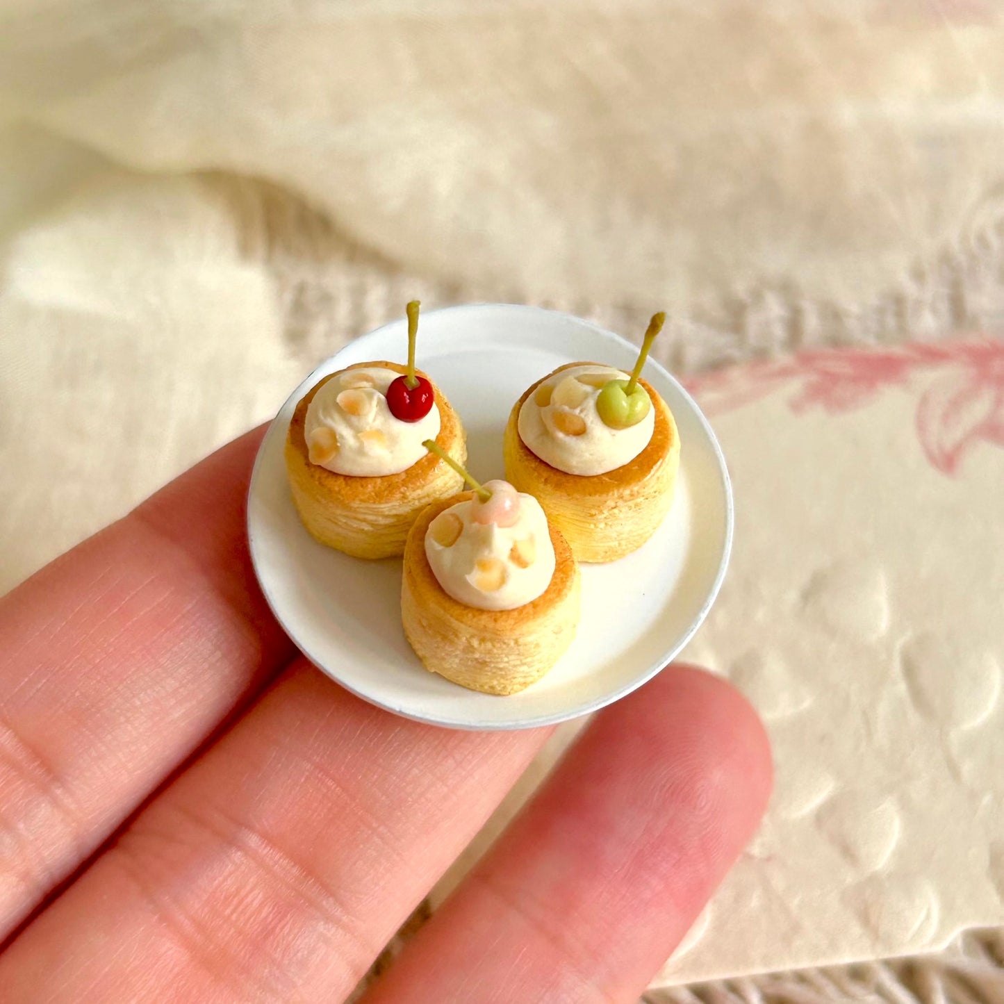 tiny handmade miniature cherry pastry held in hand