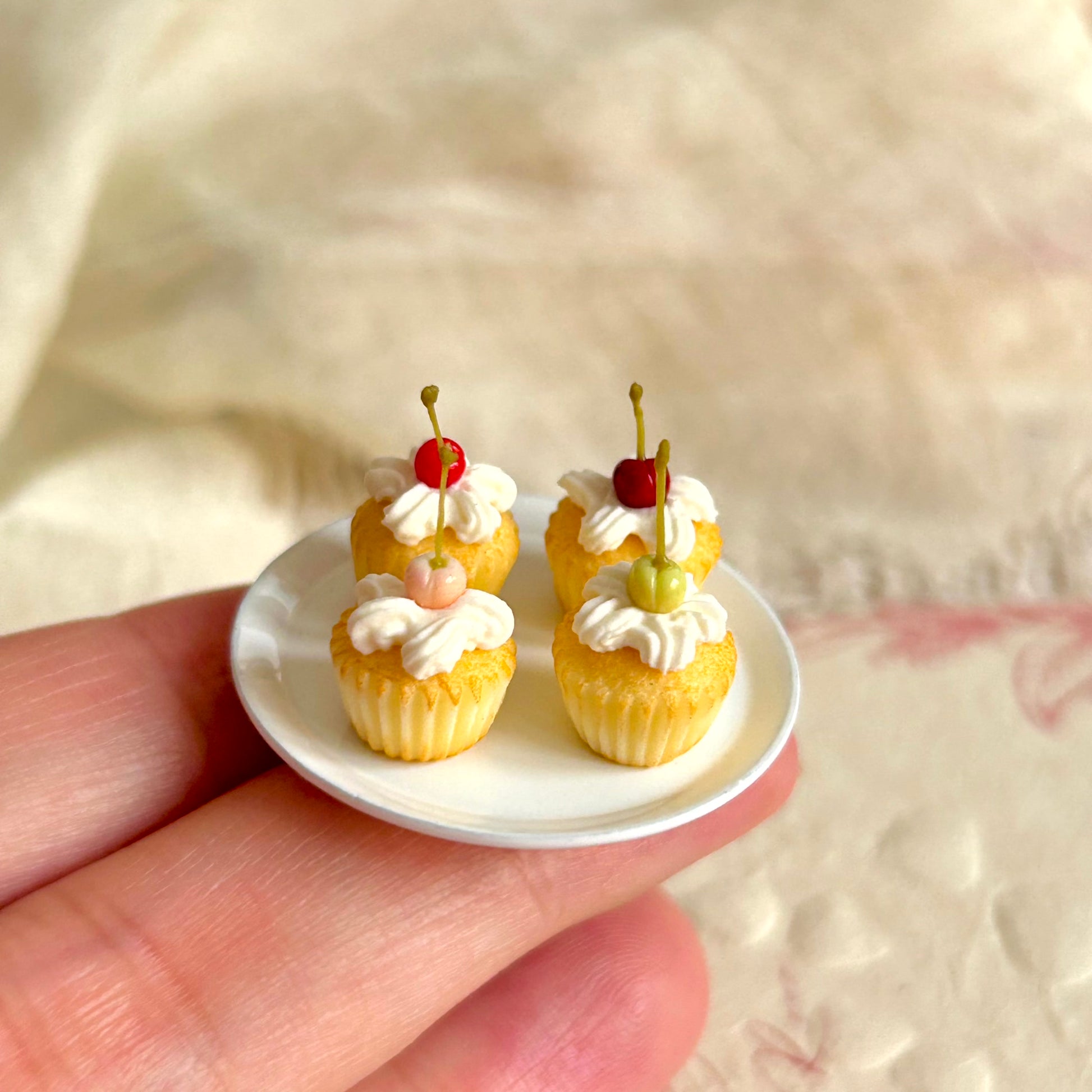 small scale handmade miniature cupcake held in hand
