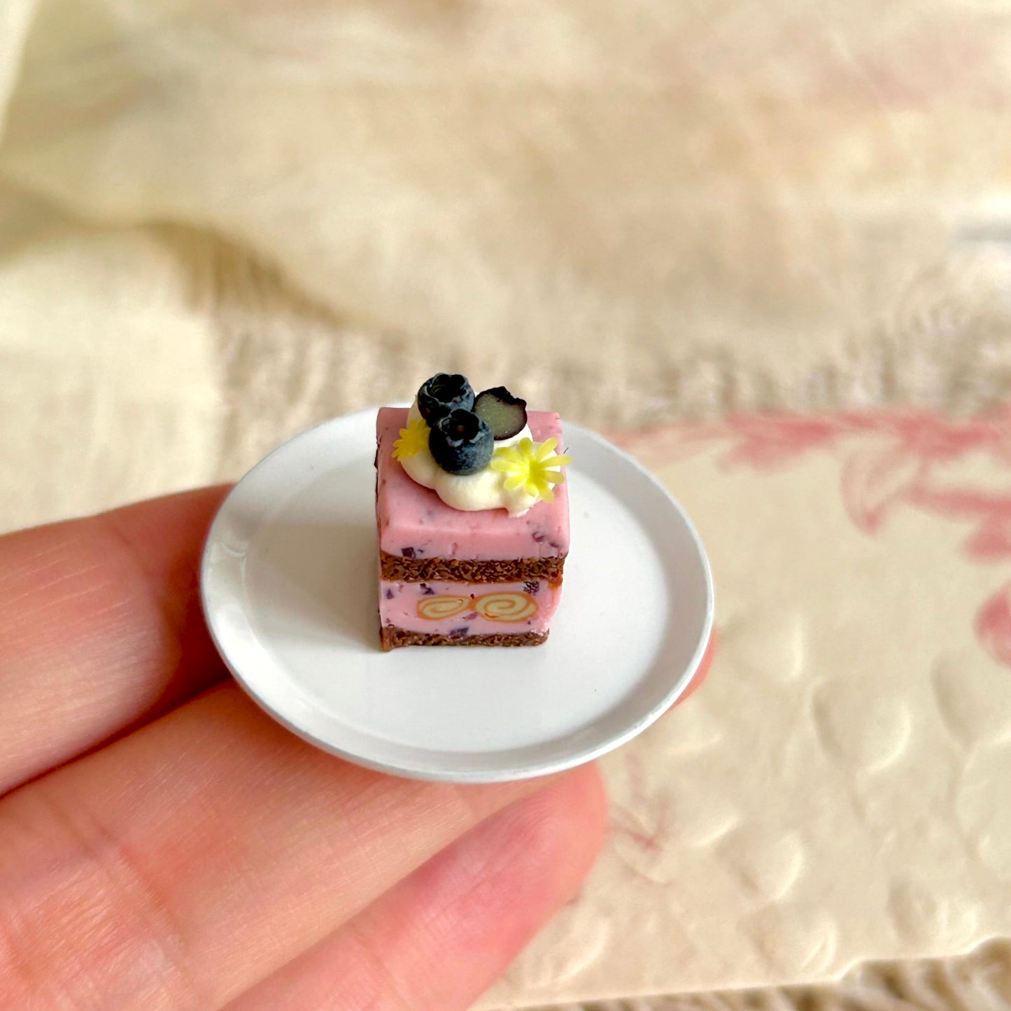 realistic miniature blueberry cake with cream and inner cake roll detail
