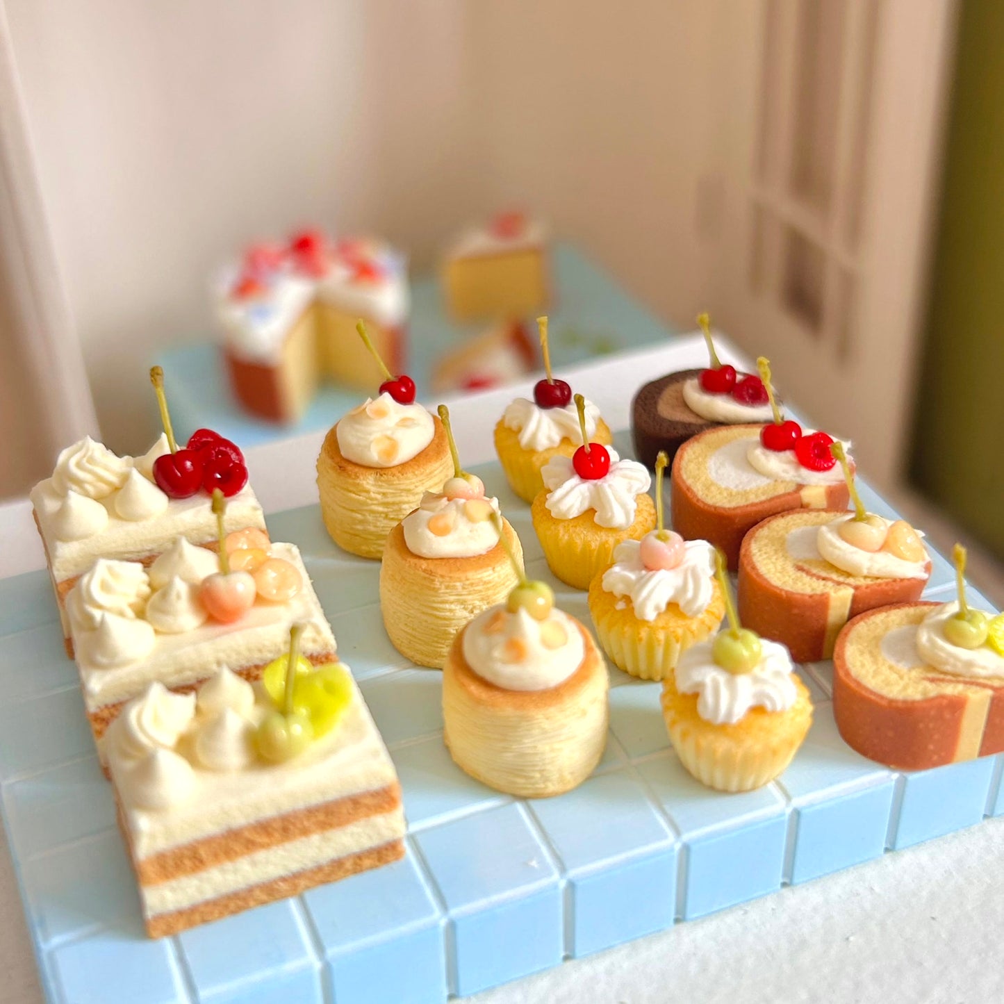 miniature dessert display featuring cherry swiss roll cake

