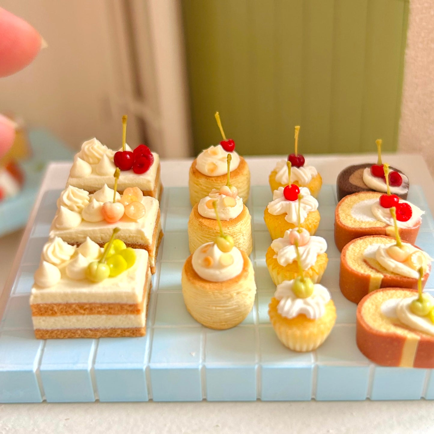 dollhouse dessert scene with handmade miniature swiss roll
