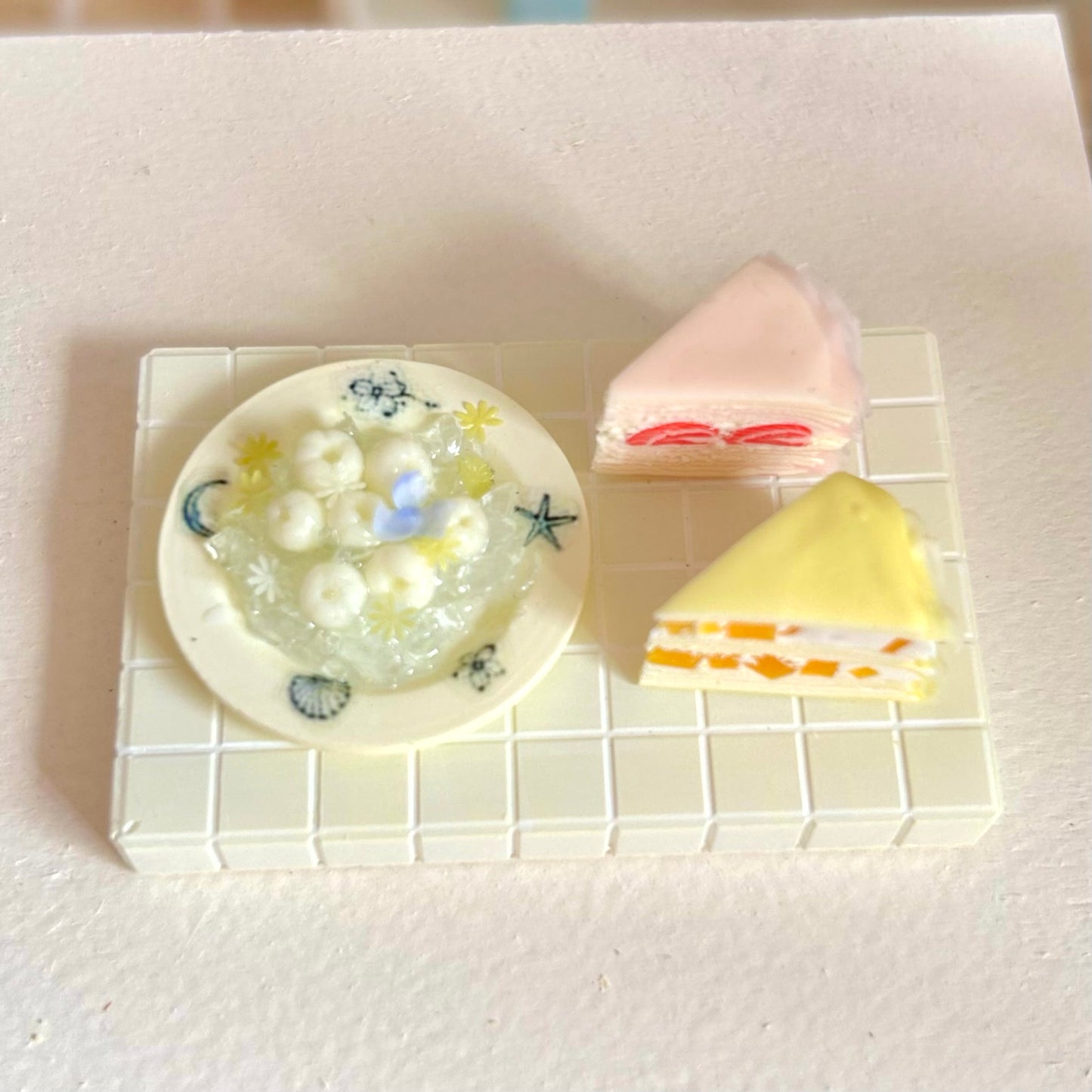 miniature dessert display featuring handmade fruit crepe cake slices