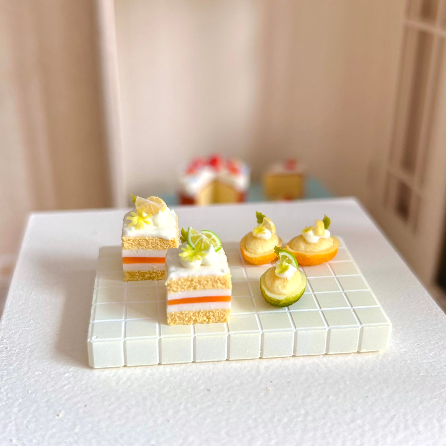dollhouse dessert scene with handmade citrus miniature cake