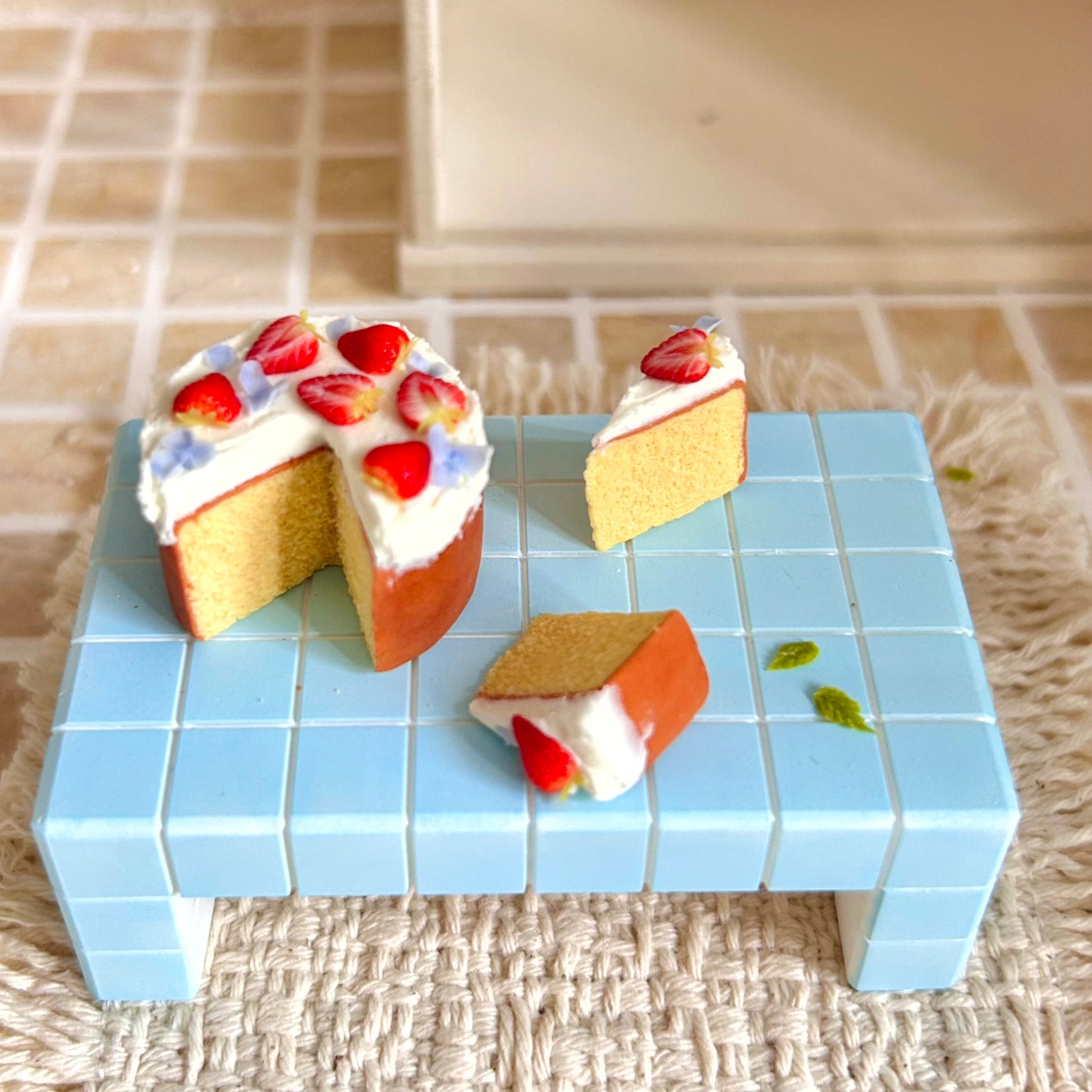 miniature chiffon cake set with separate cake slices and strawberry decoration