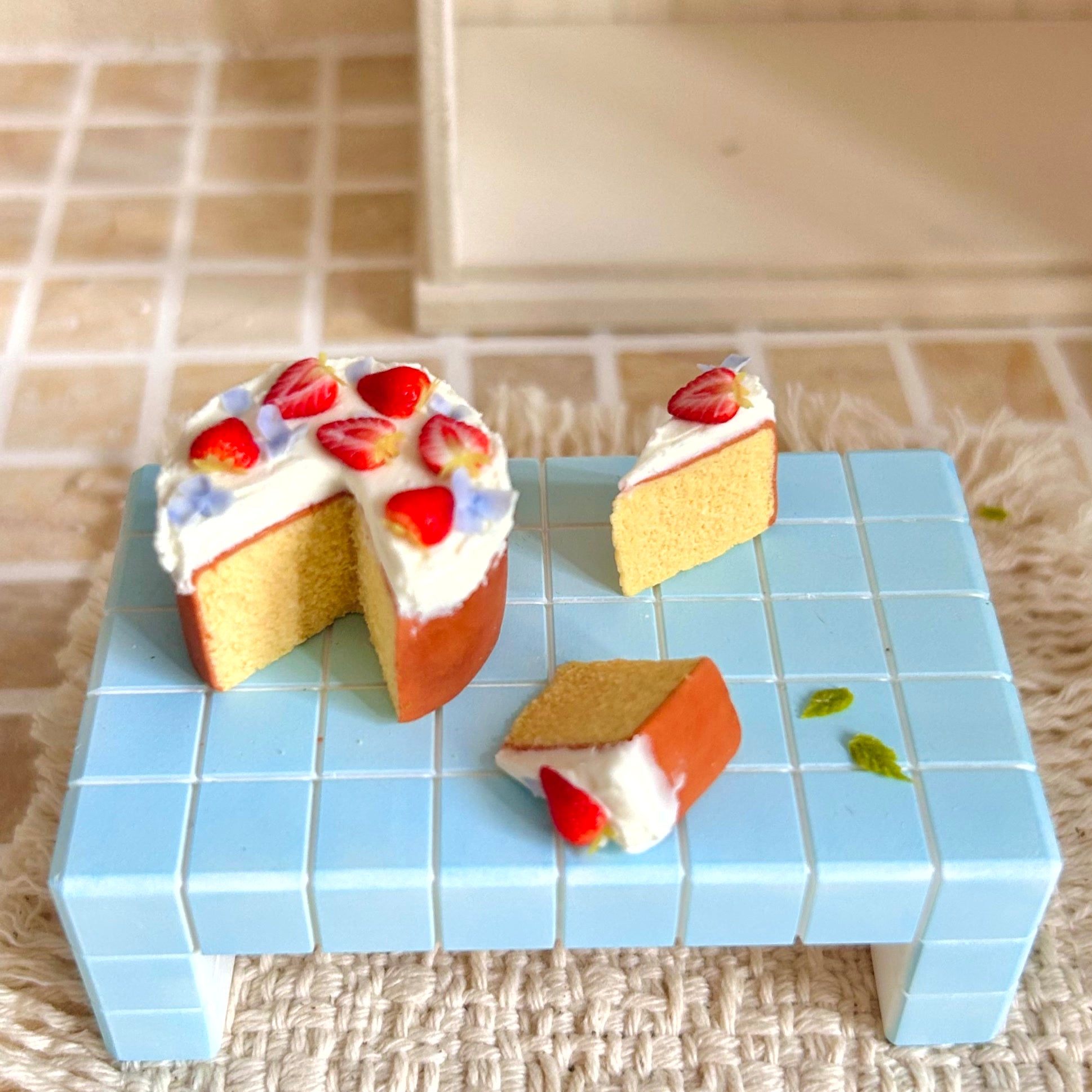 realistic miniature chiffon cake with cream topping and strawberry details