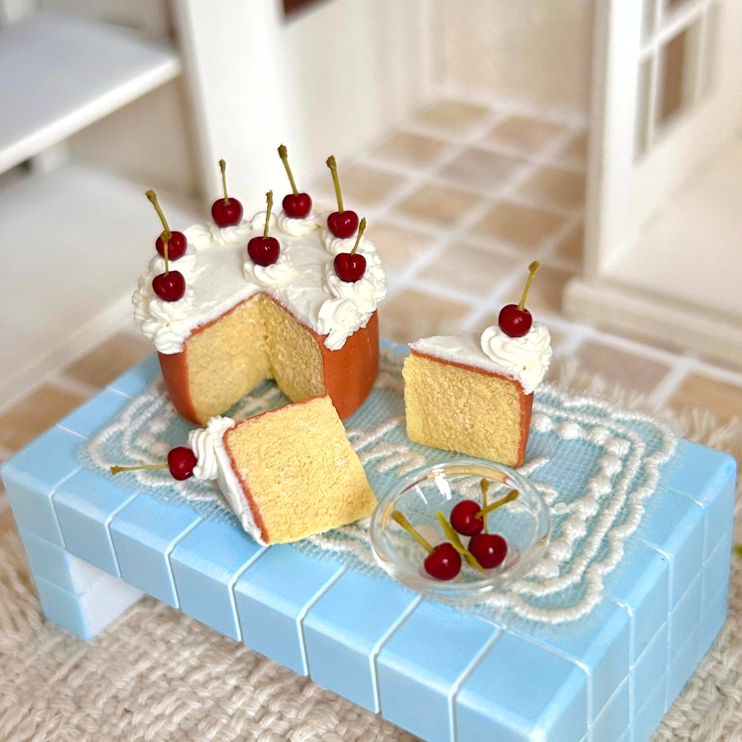 realistic miniature chiffon cake with cherry and piped cream details