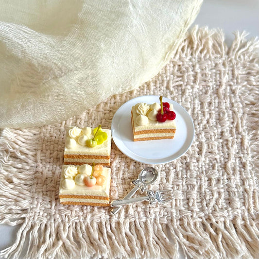 miniature cherry cake slice with cream filling and fruit decoration