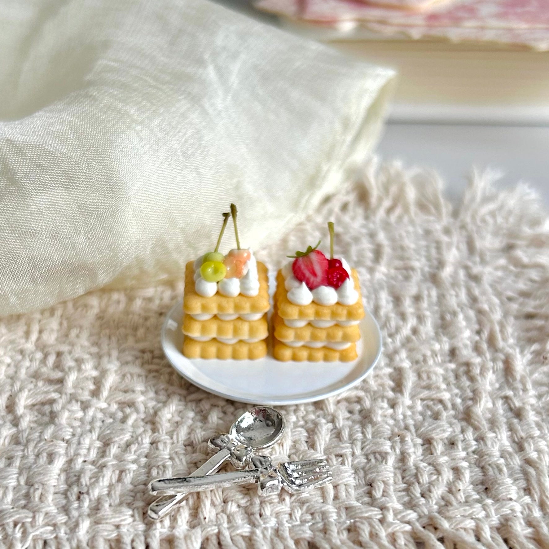 miniature layered cookie cake with cherry and strawberry decoration