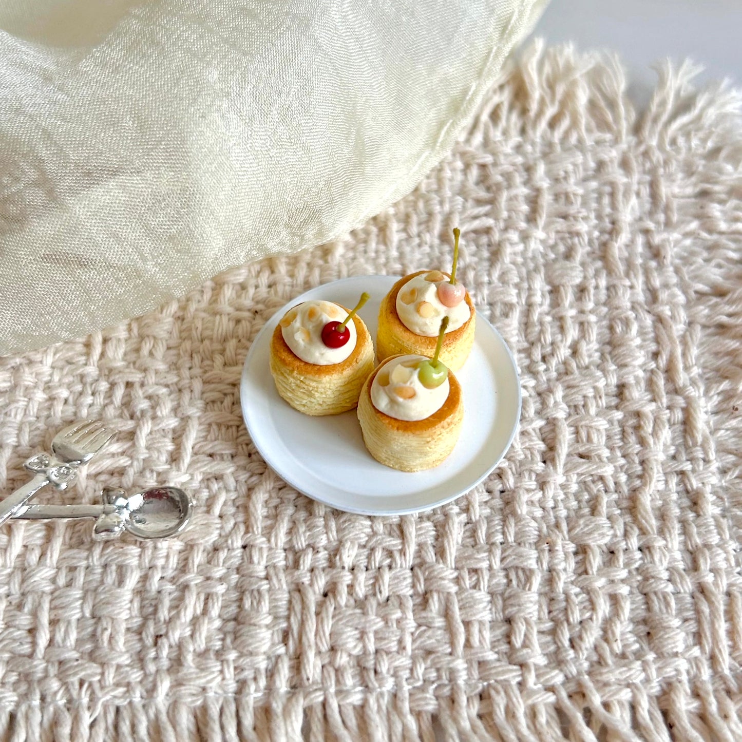 miniature cherry pastry with cream almond slices and fruit decoration

