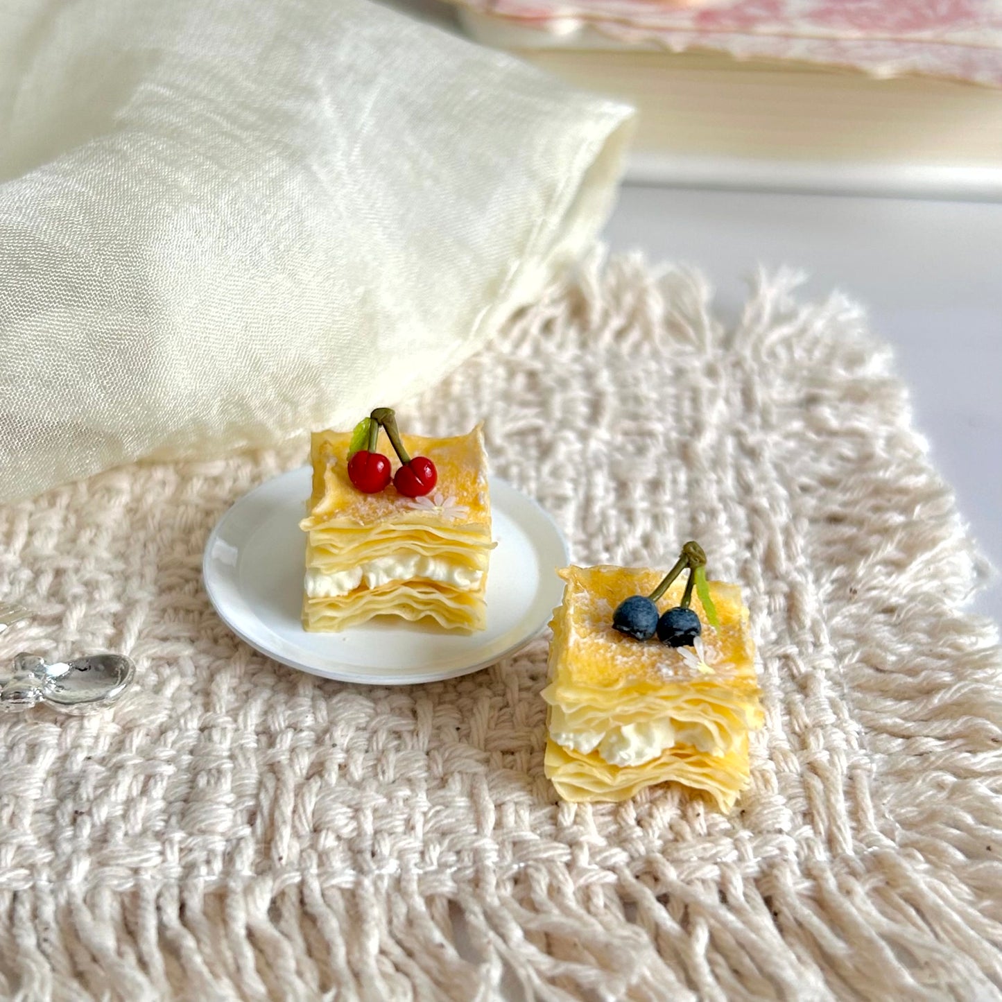 miniature mille feuille with layered puff pastry cream and fruit details