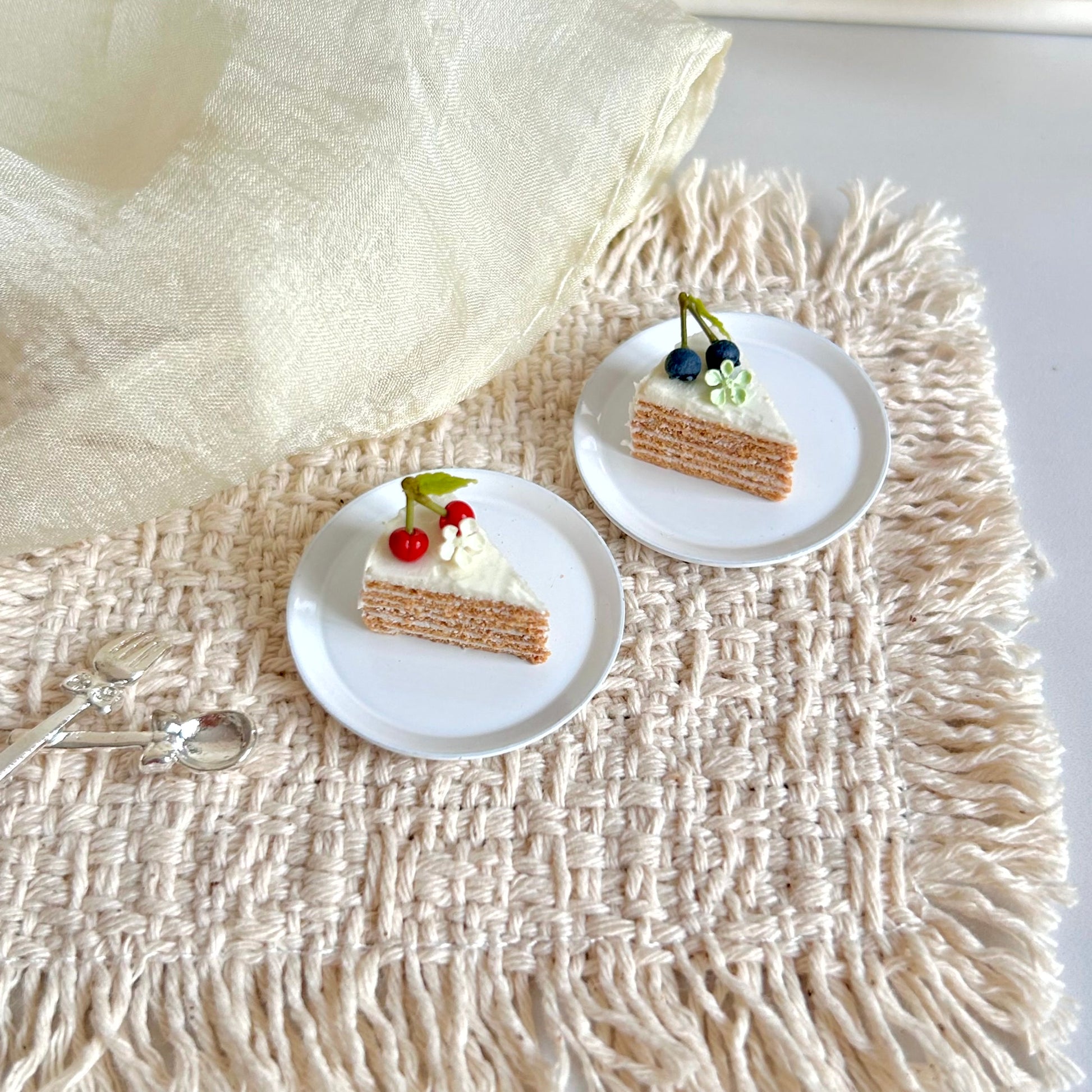 miniature vintage cake slice with thin sponge layers and cream filling
