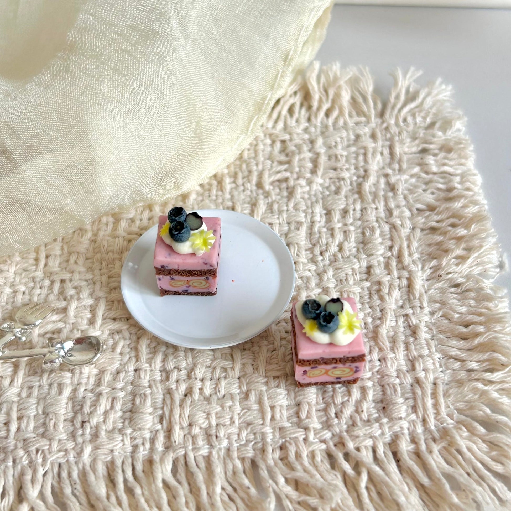 miniature blueberry cake cube with layered sponge and cream center roll
