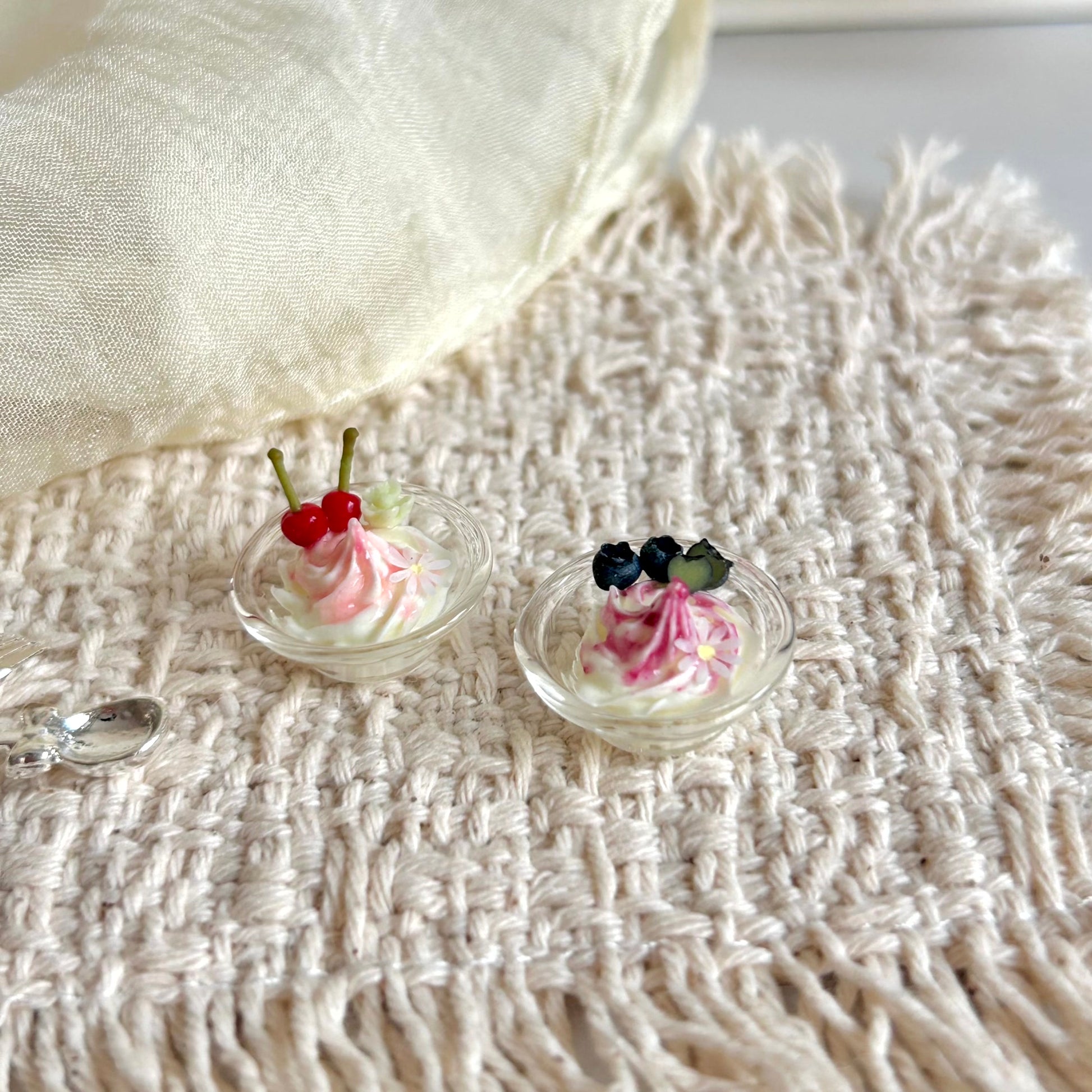 miniature ice cream in glass bowl with fruit sauce topping
