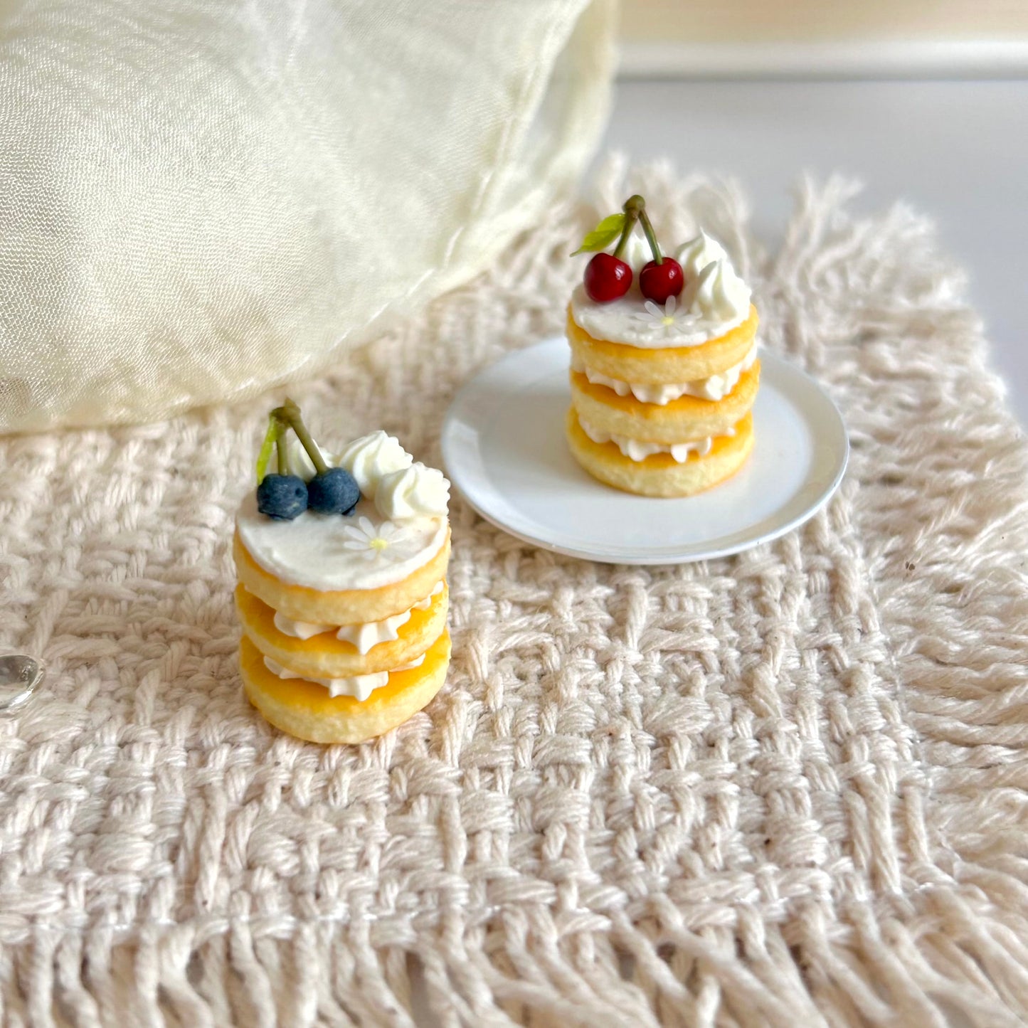 miniature round layered cake with cream and fruit topping