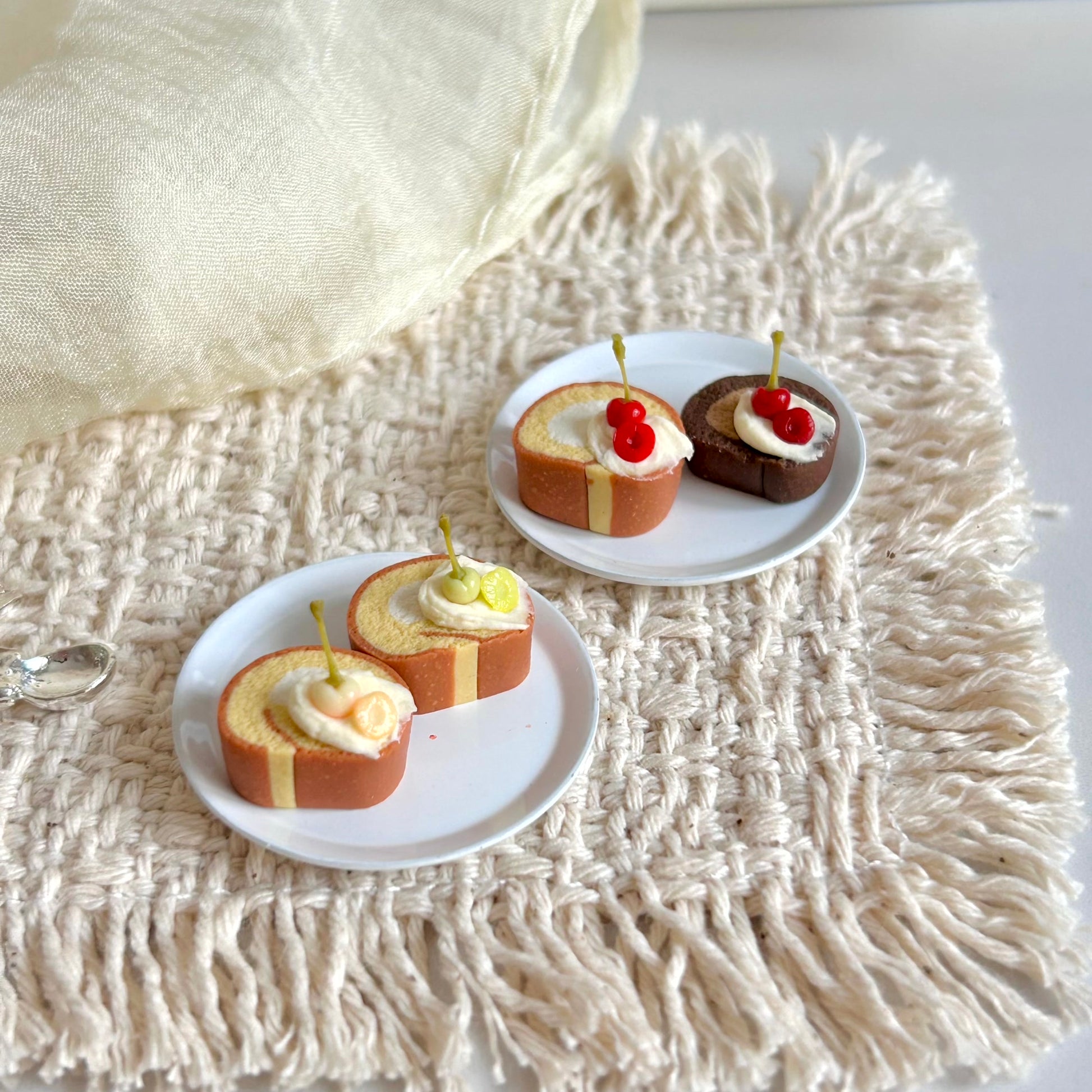 handmade miniature cherry swiss roll cake with cream topping