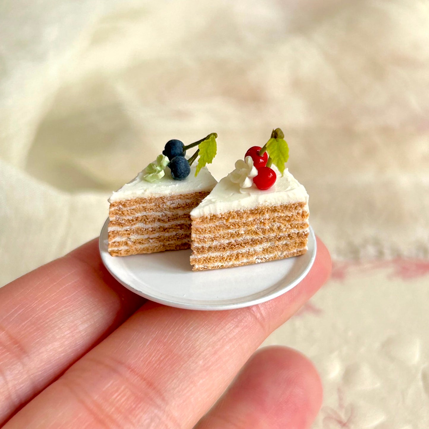 small scale handmade miniature cake slice held in hand
