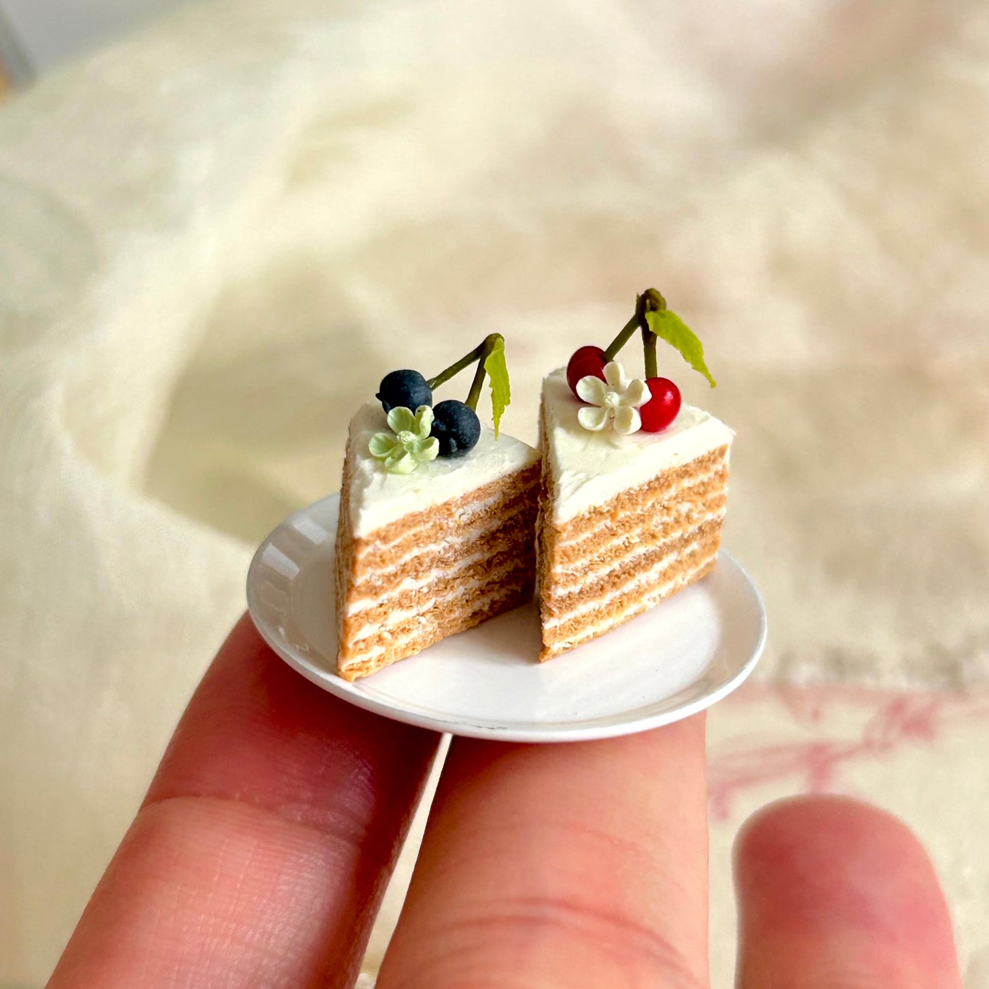realistic miniature layered sponge cake with cream and fruit details