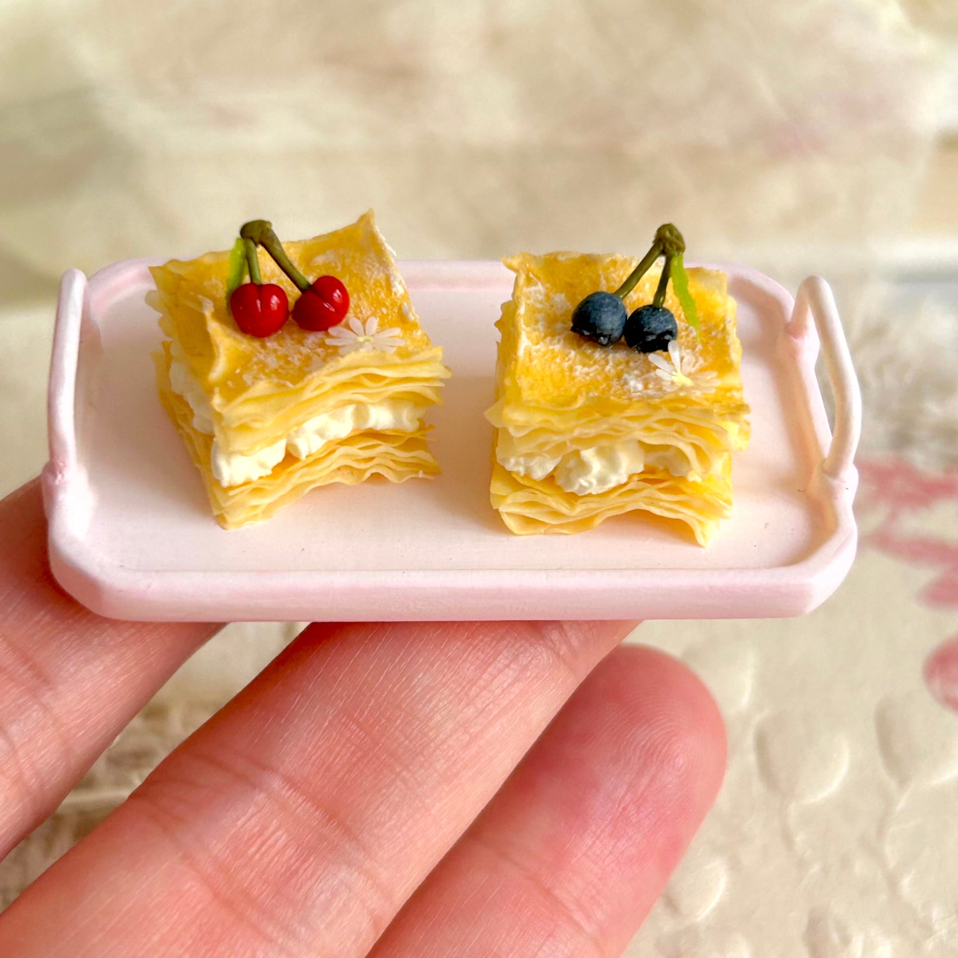 small scale handmade miniature mille feuille held in hand